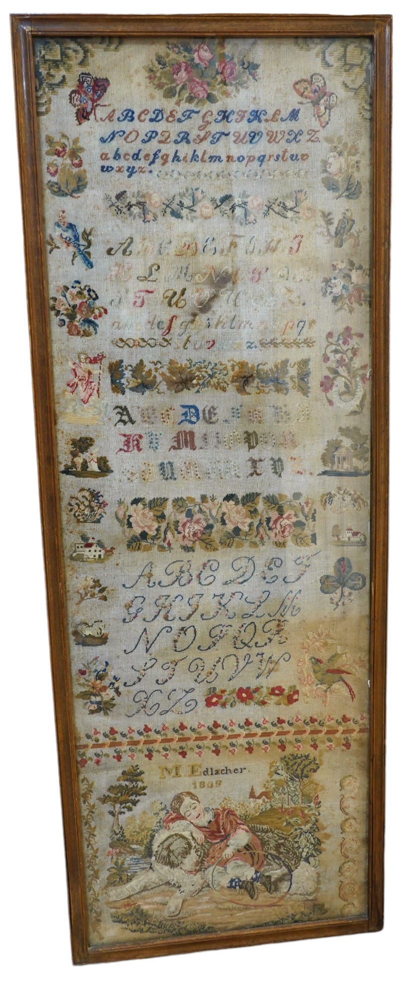 A 19th century framed alphabet sampler worked by M. Edlacher, overall 114cm high. Condition - poor